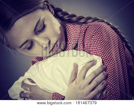 Sad Depressed Girl In Bed Gripping Pillow