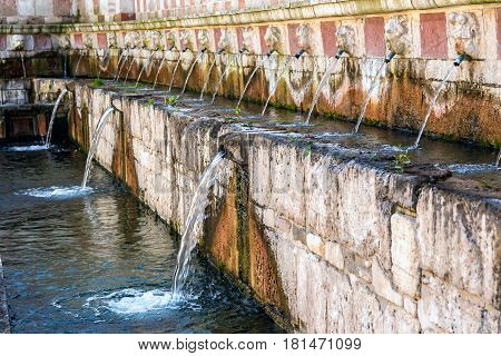 Fountain of the 99 Spouts (Fontana delle 99 cannelle) Historic fountain with 99 jets distribuited along three walls L Aquila Italy