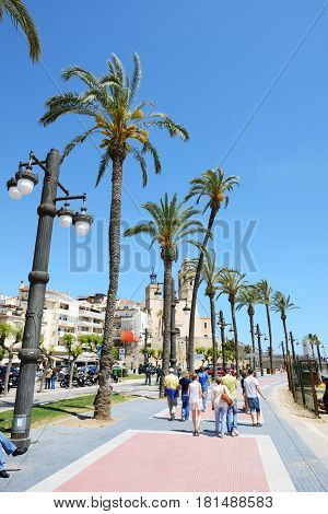 SITGES SPAIN - MAY 23: The tourists enjoiying their vacation at seafront on May 23 2015 in Sitges Spain. Up to 60 mln tourists is expected to visit Spain in year 2015.