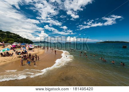 Angra dos Reis, Brazil - February 27, 2017: The beach full of people with families. During Rio Carnival holidays, many people get out of busy city and visit nearby areas like this one.