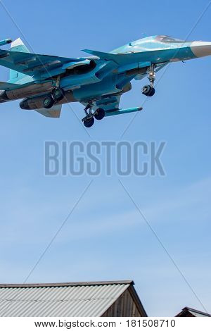 Military jet flying over the city at a low height