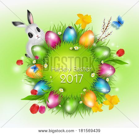 Grass circle with bright colorful eater eggs on blue background decorated with spring flowers and easter bunny
