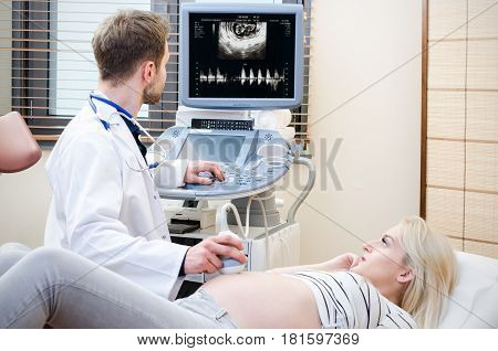 Pregnant Woman At The Doctor. Ultrasound Diagnostic Machine