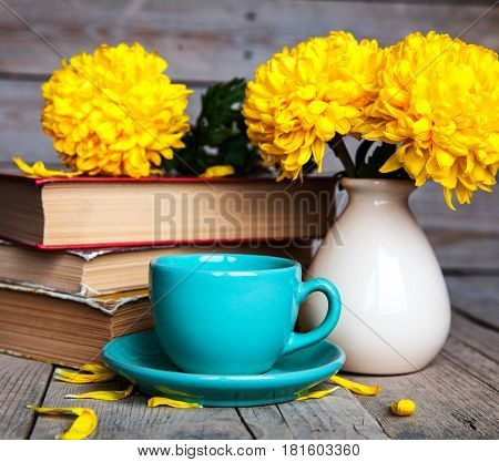 Flowers. Beautiful yellow chrysanthemum in a vintage vase. Cup of coffee. Bright Servais, cup and saucer .. Beautiful breakfast.