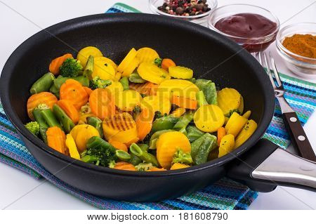 Mix of roasted vegetables in pan. Studio Photo