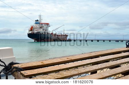 lobster pot trap with oil tanker ship at pier Picnic Center Beach Big Corn Island Nicaragua Central America