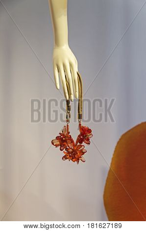 PARIS FRANCE - MARCH 27 2017: Details of the shop window decoration in the Printemps department store in Paris France. Bijouterie in the hand of a dummy.