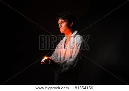 The handsome man is holding a light.
