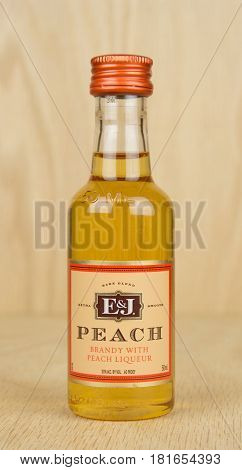RIVER FALLS,WISCONSIN-APRIL 05,2017: A bottle of E&J brand peach brandy with a wood background.