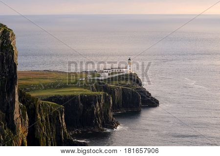 Scenic views of Neist Point Lighthouse at dusk in Scotland.