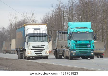LENINGRAD REGION, RUSSIA - MARCH 09, 2017: Trucks on the highway M10 Moscow-St.-Petersburg cloudy March afternoon
