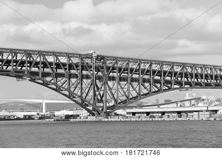 Black and White Minato Bridge cross over Osaka ocean skyline Japan