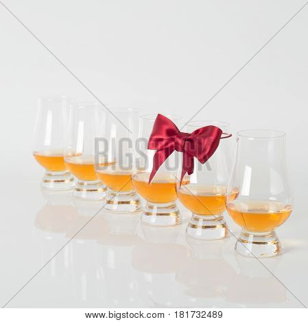 Set Of Single Malt Tasting Glasses, Single Malt Whisky In A Glasses, White Background, Red Bow
