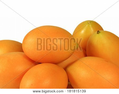 Heap of Vibrant Yellow Fresh Ripe Marian Plums Isolated on White Background