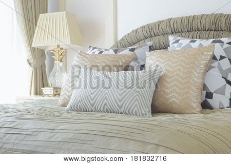 Golden And Silver Pillows Setting On Bed With Luxury Style Interior Bedroom