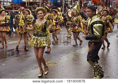 ORURO, BOLIVIA - FEBRUARY 26, 2017: Caporales dancers in ornate costumes performing as they parade through the mining city of Oruro on the Altiplano of Bolivia during the annual carnival.