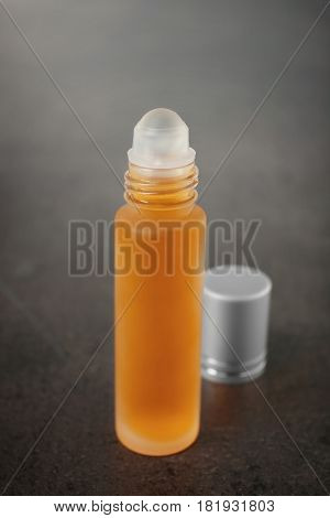 Open bottle with perfume on grunge background