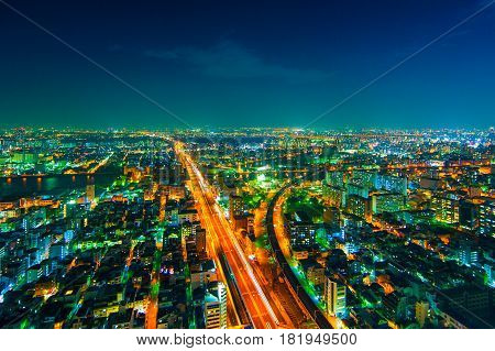 The image of the night city from the height of a bird's flight.A view of the night Osaka.Mnogo houses in iluminatsii.Dark time of the day