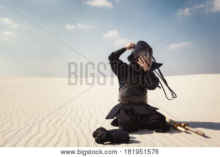 Warrior, Man Sits In The Wilderness And Dresses Traditional Helmet For Kendo