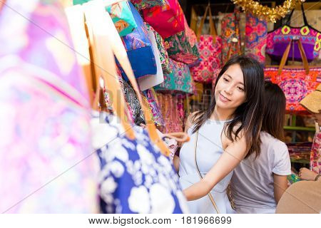 Woman choosing bag in bangkok city