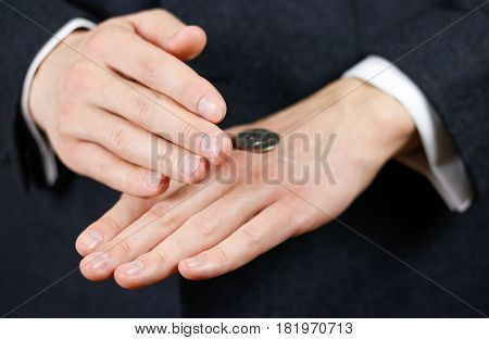 Businessman Tossing A Coin. Heads Or Tails. Close Up
