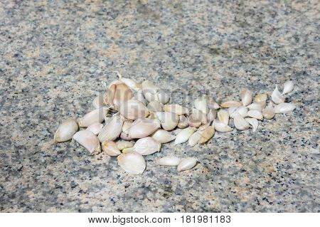 Group of garlic's is on granite stone.