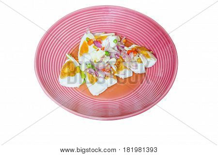 Thai food : spicy egg salad with shallots garlic and chili on pink dish. Top view. It isolated white background.