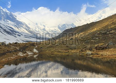 Himalaya Annapurna snow mountain range with reflection on pond on the way to Annapurna base camp famous trekking trail in Nepal.