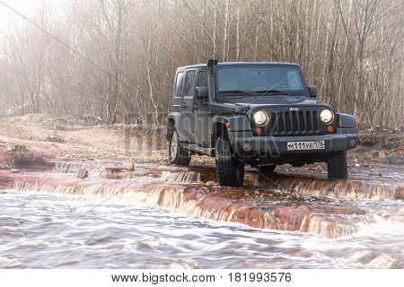 Leningrad region, Russia - April 16, 2017. Jeep Wrangler on the shore of the river Wrangler is a compact SUV produced by Chrysler