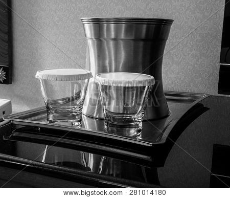 Steel Tray With Two Tumblers Covered By Paper Lids And Bucket For Ice.