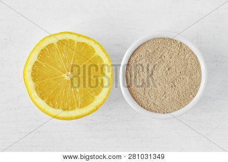 Homemade Face Mask Made Out Of Lemon And Moroccan Rhassoul (ghassoul) Clay On Wooden Background