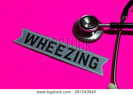 Wheezing On The Paper With Healthcare Concept. With Stethoscope On Pink Bakcground