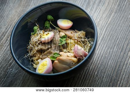 Top View Noodles Dish With Shiitake Mushrooms, Eggs, Wheat Sprouts And Pitcher With Broth