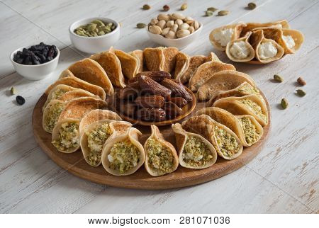 Arab Sweets. Arabian Pancake Stuffed With Sweet Cheese And Pistachios.
