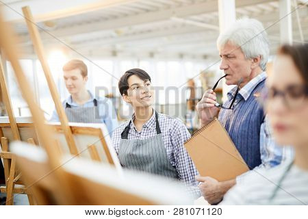 Portrait Of Smiling Art Student Looking At Teacher During Class In Workshop Studio, Copy Space