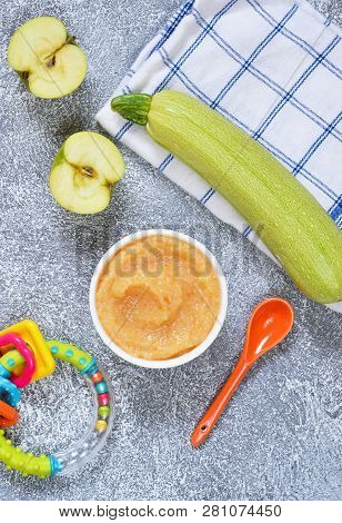 Baby Food From 6 Months. Vegetable Puree From Courgettes, Stamps And Potatoes On A Concrete Backgrou