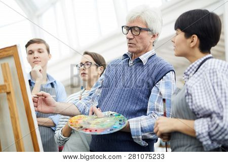 Waist Up Portrait Of Mature Art Teacher Working With Group Of Students In Art Class, Copy Space