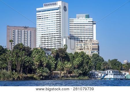 Egypt, Cairo, November, 2017 - Buildings Of Modern Hotels Among Palm Trees On The Riversaid Nile And