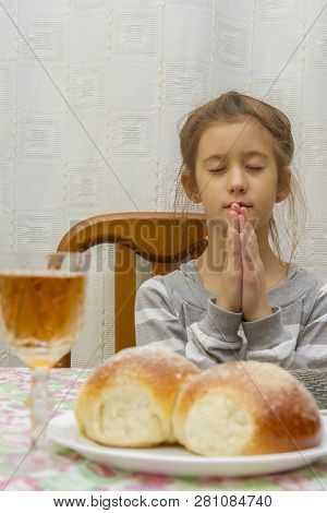 Child Prays At Shabbat. Little Jewish Sabbath. Jewish Child At The Sabbath Table. Vertical Photo