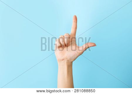 Woman Showing L Letter On Color Background, Closeup. Sign Language