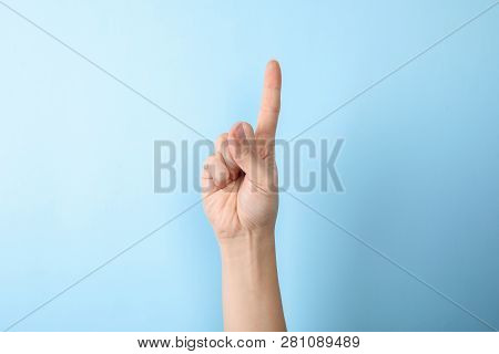 Woman Showing Number One On Color Background, Closeup. Sign Language