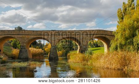 A Sunny Autumn View Of The Historic Old Stone Bridge In Richmond, Tasmania, The Oldest Bridge Still 