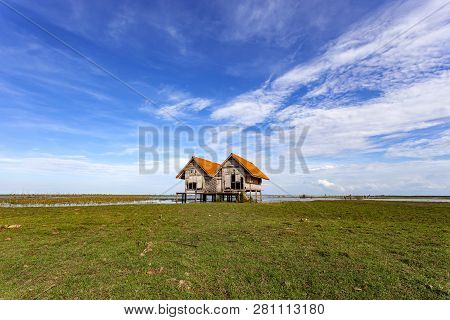 Old House At Thale Noi With Blue Sky, Chaloem Phrakiat Bridge, Phatthalung Province In Thailand.