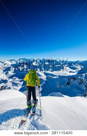 Skitouring with amazing view of swiss famous mountains in beautiful winter powder snow of Alps. 