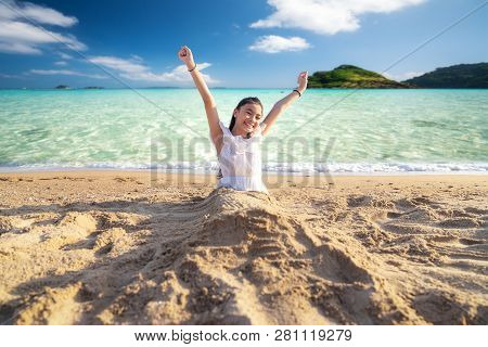 Asian Girl Play With Sand On The Beach And Island Background, This Immage Can Use For Travel, Relax 