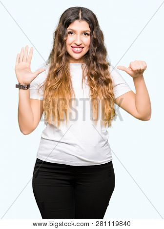 Young beautiful woman wearing casual white t-shirt showing and pointing up with fingers number six while smiling confident and happy.