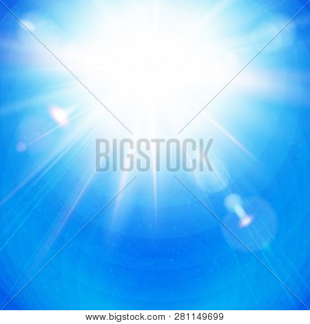 Bright Sunburst With Radiating Rays In A Clear Blue Sky.