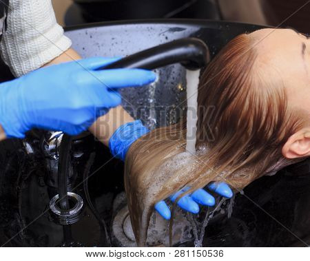 Girl In A Beauty Salon. Wash Your Hair, Hair Care, Health. Combing Of Washed Hair With A Special Com