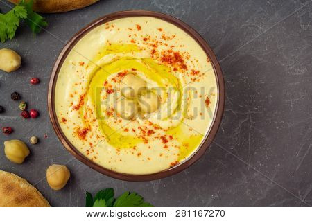 Chickpea Hummus In A Bowl, Ingredients, Pita Bread On Grey Background. Top View, Copy Space.