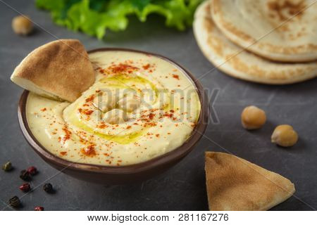 Chickpea Hummus In A Bowl And Pita Bread On Gray Background. Mediterranean Snack, Vegetarian Healthy